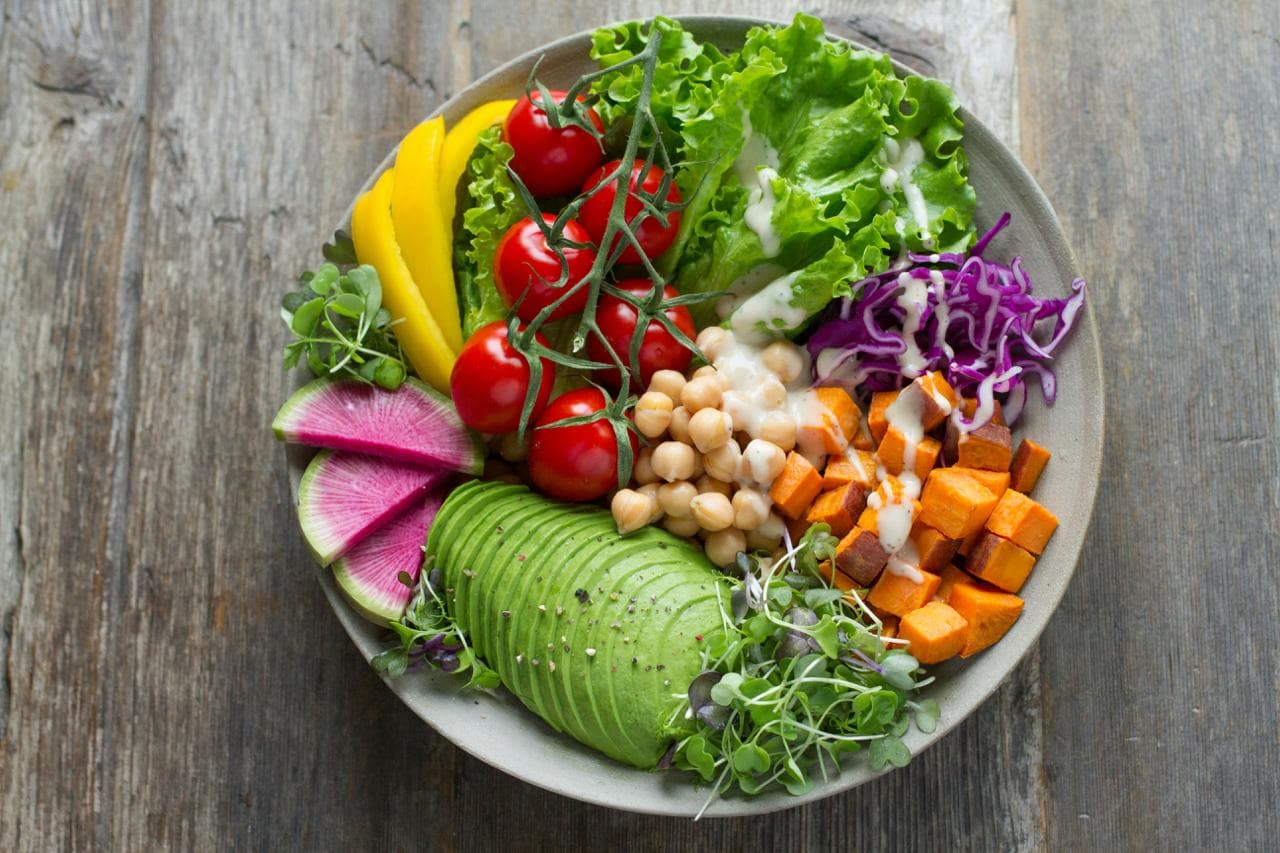 Flat lay of fresh produce, supplements, and a personalized nutrition plan