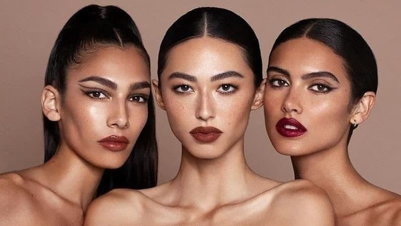 Potret hitam putih perempuan berkalung dengan rambut belah tengah yang rapi dan simetris